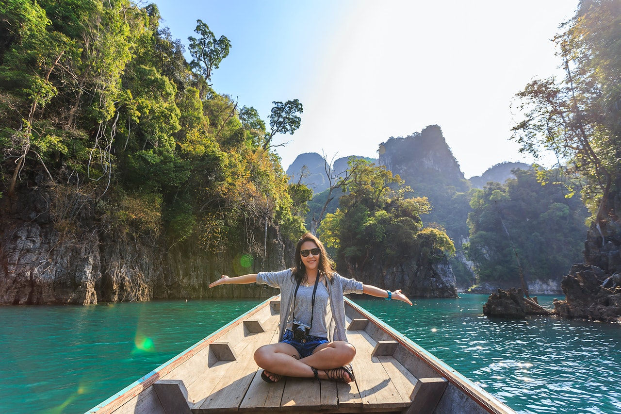 photo-of-woman-sitting-on-boat-spreading-her-arms-1371360